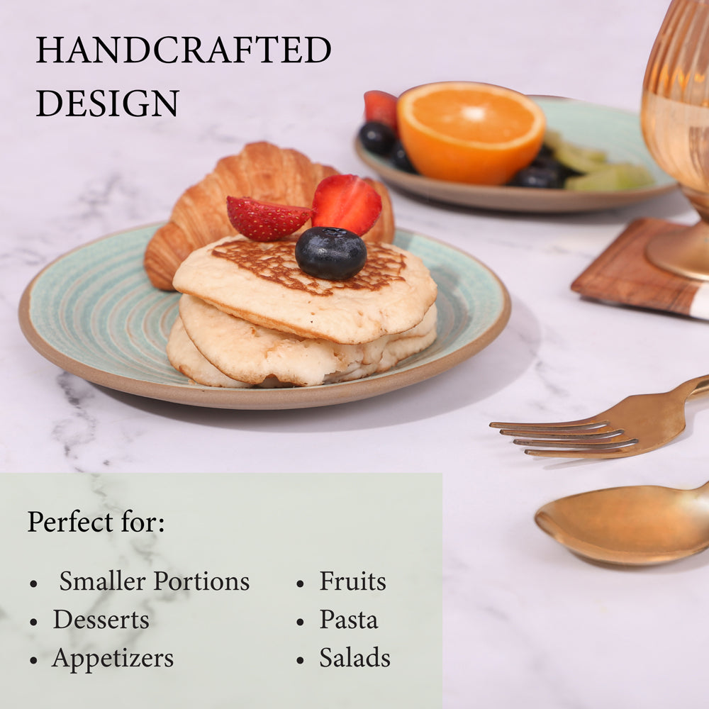 Set of two quarter plates with food, featuring a croissant and pancakes on one plate, and fresh fruits like kiwi, orange, and berries and Handcrafted Design
