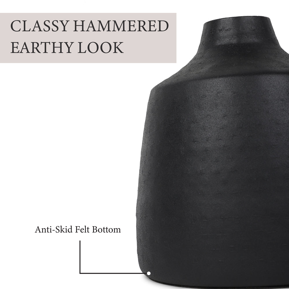Close-up of a black vase with a hammered texture and anti-skid felt bottom, showcasing a classy and earthy look