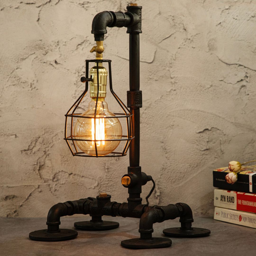 This industrial-style desk lamp features a creative plumbing pipe design and a retro cage bulb holder, blending vintage aesthetics with modern functionality.