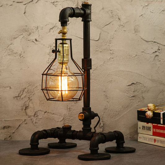 This industrial-style desk lamp features a creative plumbing pipe design and a retro cage bulb holder, blending vintage aesthetics with modern functionality.