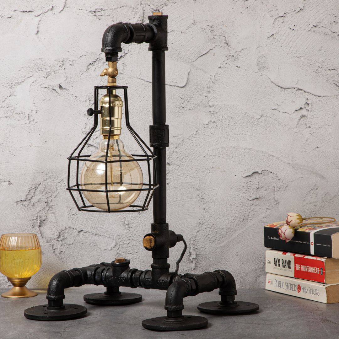 This industrial-style desk lamp features a creative plumbing pipe design and a retro cage bulb holder, blending vintage aesthetics with modern functionality.