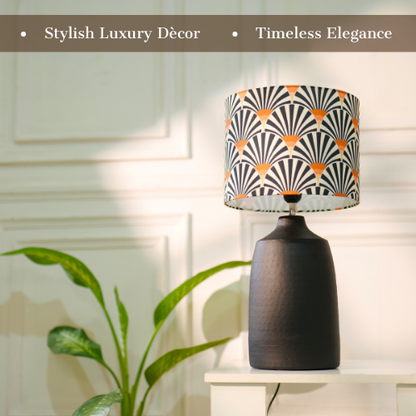 Elegant table lamp with colorful artistic shade on wooden base, placed on a desk
