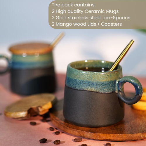 Pack containing two ceramic mugs with mango wood lids, gold stainless steel tea-spoons, and coasters, displayed with coffee beans and text listing the contents
