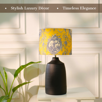 Elegant table lamp with colorful artistic shade on wooden base, placed on a desk — thumbnail