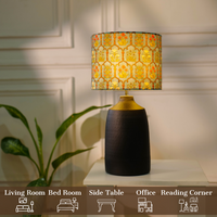 Elegant table lamp with colorful artistic shade on wooden base, placed on a desk — thumbnail