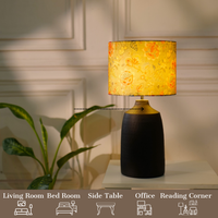 Elegant table lamp with colorful artistic shade on wooden base, placed on a desk — thumbnail