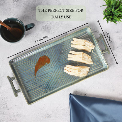 Rectangular ceramic serving tray with teal patterns, measuring 13x6 inches, featuring handles and sandwiches placed on top