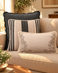 Charcoal solid layered behind CIREL and IVOIRE cushions on a sofa — thumbnail