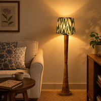 Hara Ikat scalloped lamp shade on the mango wood column floor lamp beside a linen sofa — thumbnail