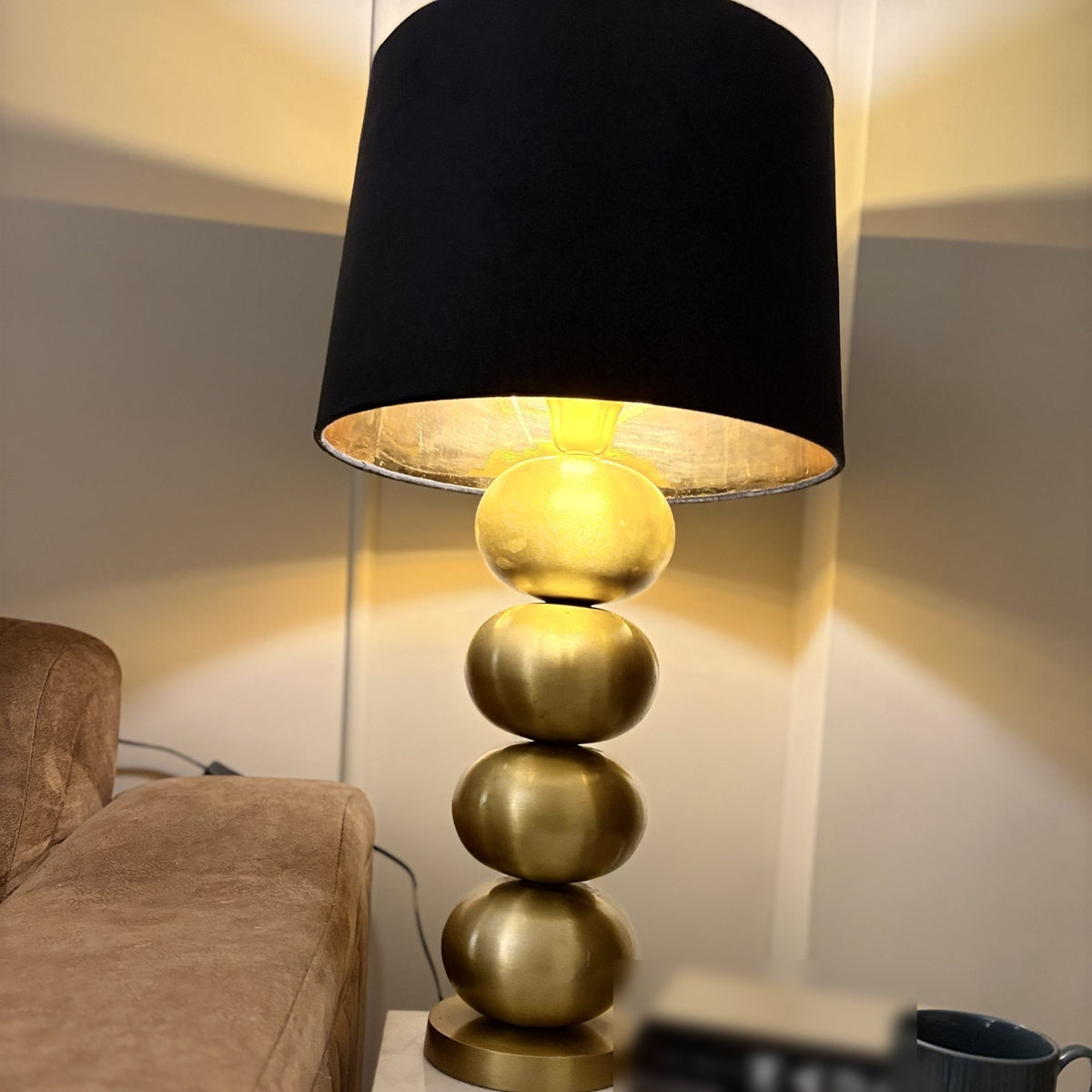 Raat Velvet Drum Lamp Shade lit on gold Column Table Lamp at night