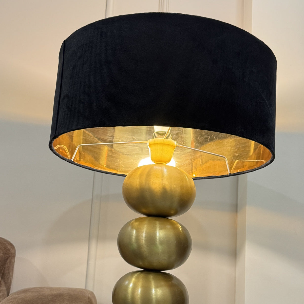 Raat Velvet Wide Drum Lamp Shade lit on gold Column Table Lamp