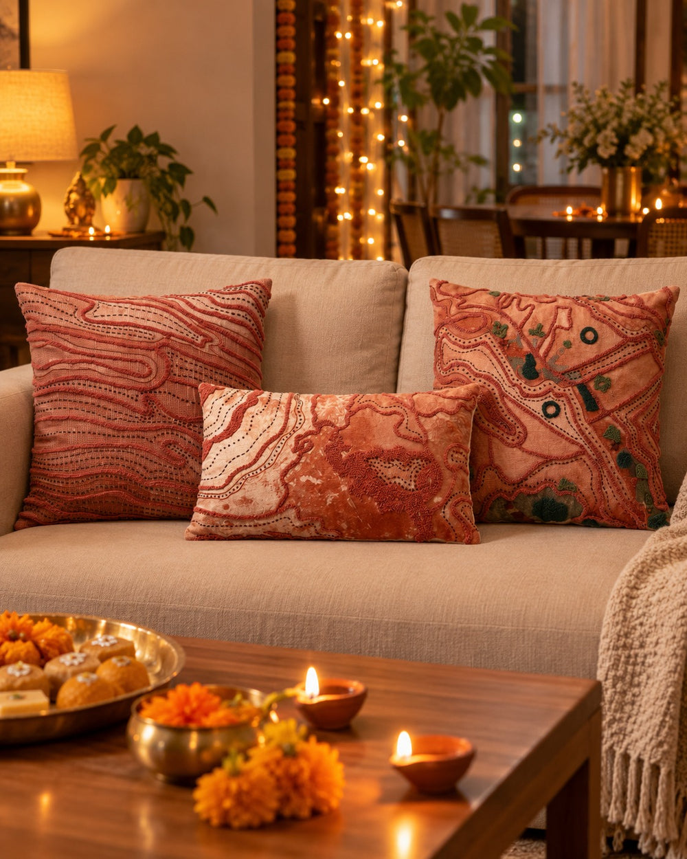Beige sofa with DREAMYWALLS Earth Series aari-embroidered cushions on Diwali evening