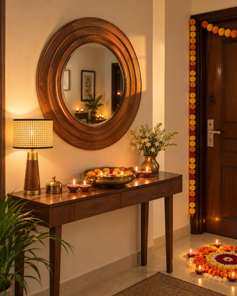 Vritta round wooden mirror above a console with the A-shape rattan lamp and diyas
