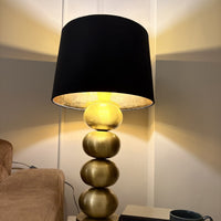 Raat Velvet Drum Lamp Shade, lit on a brass base — thumbnail
